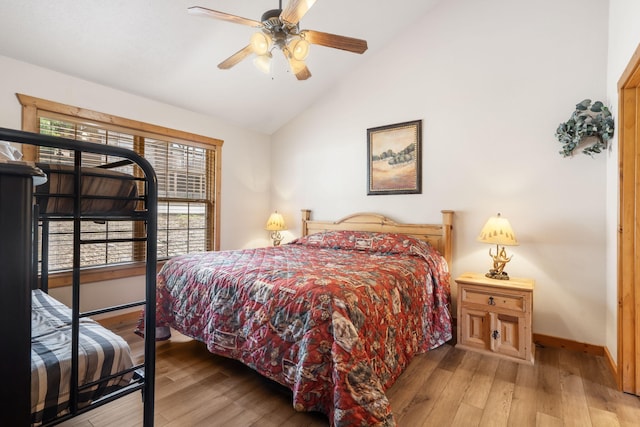 bedroom featuring high vaulted ceiling, ceiling fan, and light hardwood / wood-style flooring