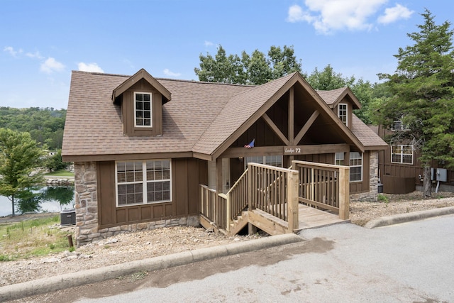 view of front of property with central AC unit and a wooden deck