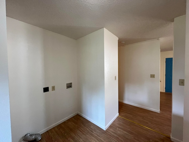 laundry room featuring washer hookup, dark wood-type flooring, and a textured ceiling