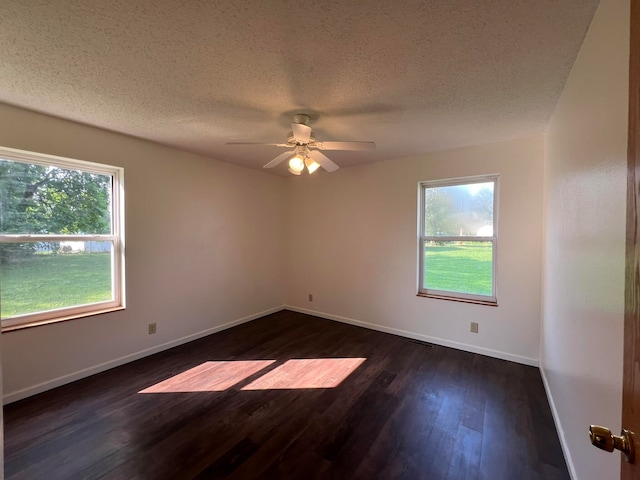 spare room featuring ceiling fan, dark hardwood / wood-style flooring, and a textured ceiling