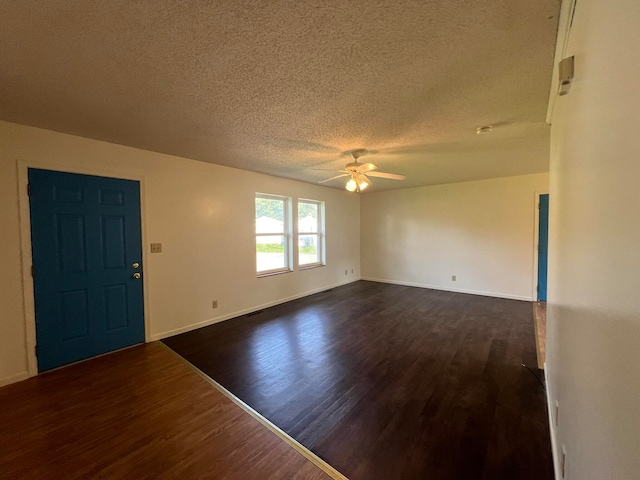 interior space featuring dark hardwood / wood-style floors, a textured ceiling, and ceiling fan