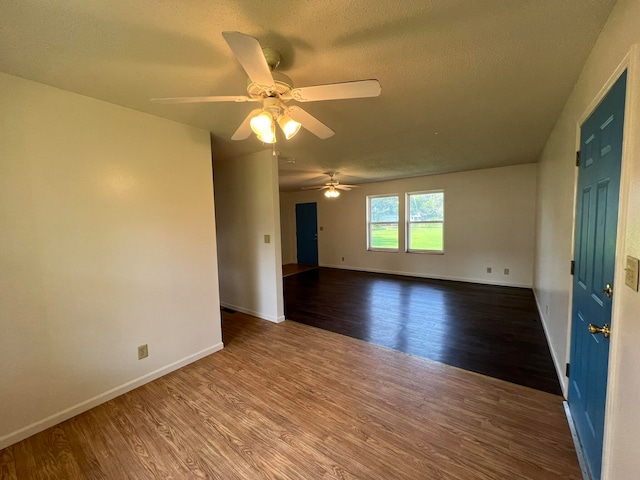 empty room with hardwood / wood-style floors, a textured ceiling, and ceiling fan