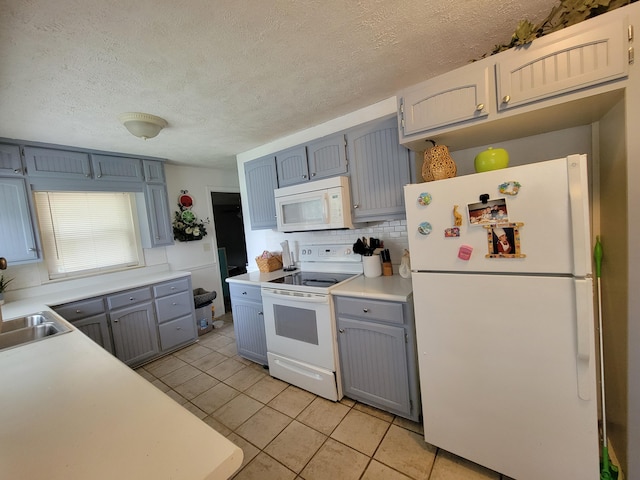 kitchen with white appliances, a textured ceiling, decorative backsplash, and light tile patterned flooring