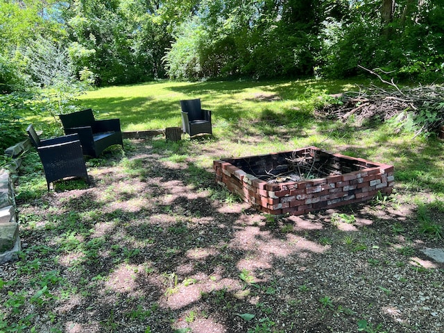 view of yard with a fire pit