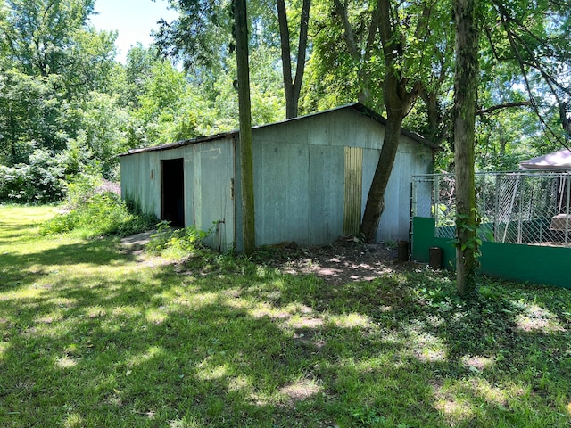 view of outbuilding with a yard