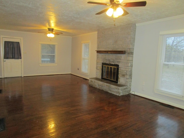 unfurnished living room with ceiling fan, dark hardwood / wood-style flooring, a textured ceiling, and crown molding