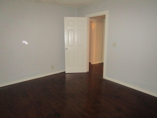 spare room featuring dark hardwood / wood-style flooring