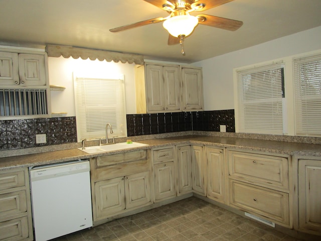 kitchen featuring cream cabinetry, dishwasher, sink, and backsplash