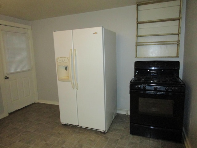 kitchen featuring white refrigerator with ice dispenser and black gas stove