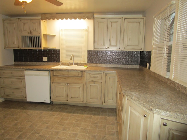 kitchen with tasteful backsplash, ceiling fan, sink, and white dishwasher