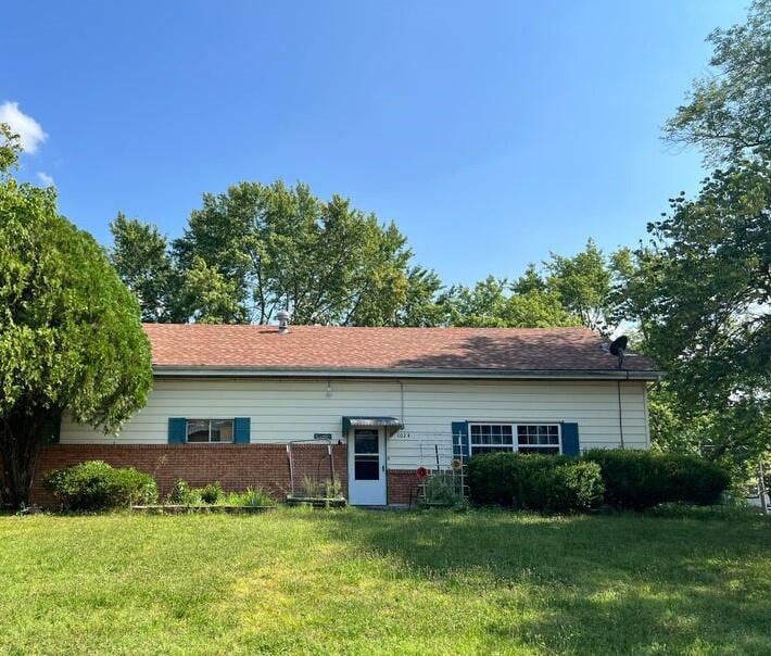 back of property featuring a lawn