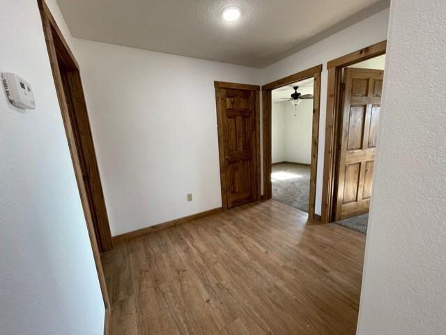 unfurnished room with hardwood / wood-style flooring and ceiling fan