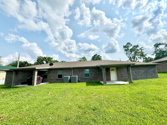 back of property featuring a patio area and a lawn