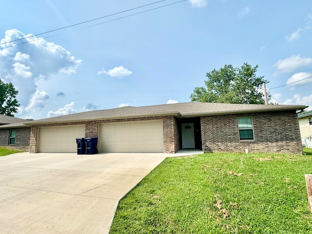 ranch-style house featuring a front lawn and a garage