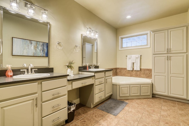 bathroom featuring tile patterned floors, vanity, and a washtub