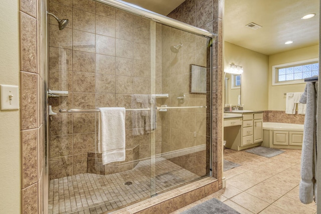 bathroom featuring tile patterned flooring, a shower with door, and vanity