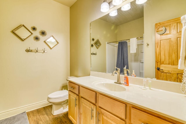 bathroom with hardwood / wood-style floors, vanity, toilet, and a shower with shower curtain