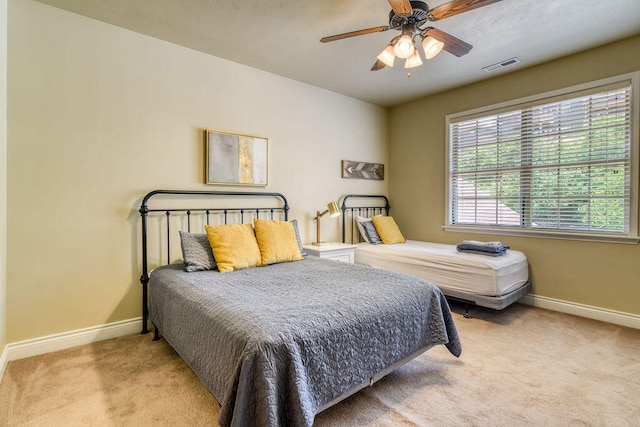 bedroom featuring ceiling fan and light colored carpet