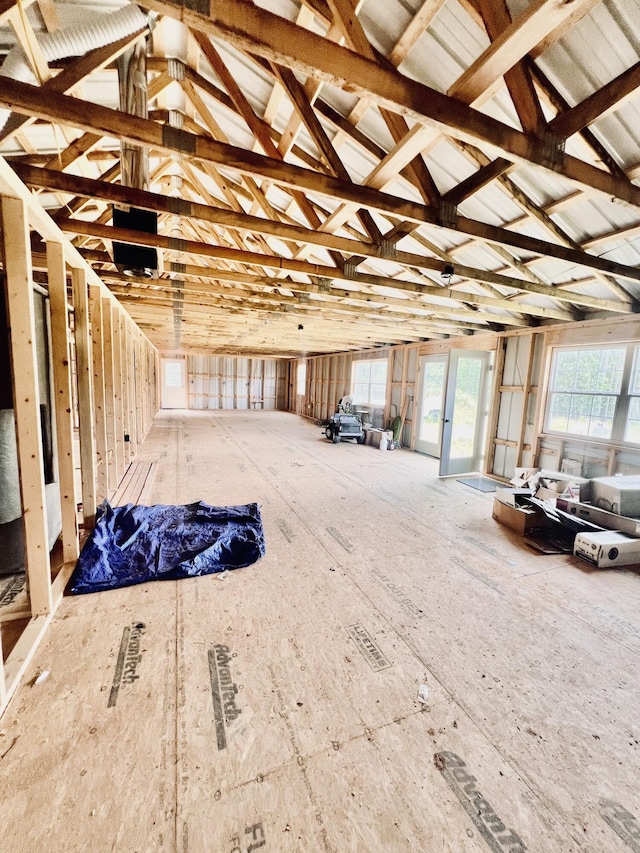 miscellaneous room featuring lofted ceiling and a healthy amount of sunlight