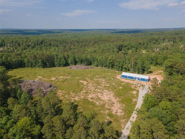 drone / aerial view featuring a forest view