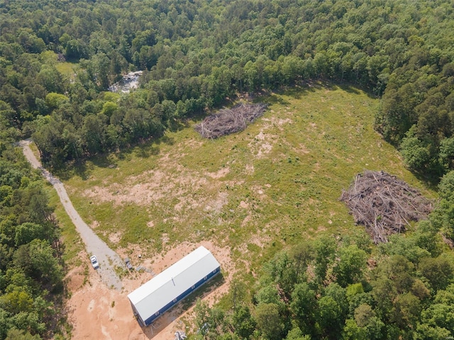 bird's eye view with a wooded view