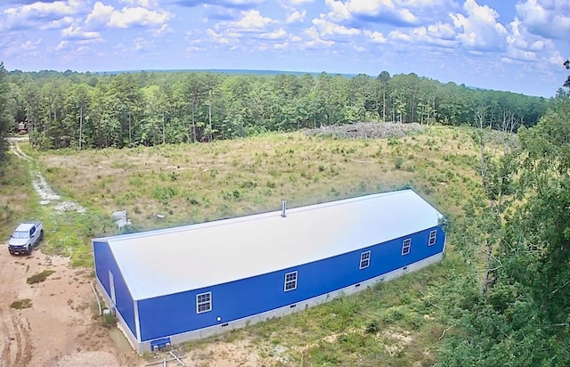 drone / aerial view featuring a forest view