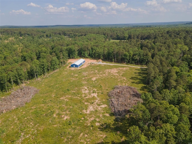drone / aerial view with a wooded view