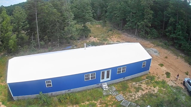 birds eye view of property with a wooded view