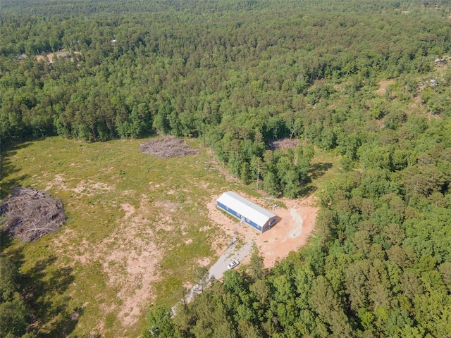 birds eye view of property with a view of trees