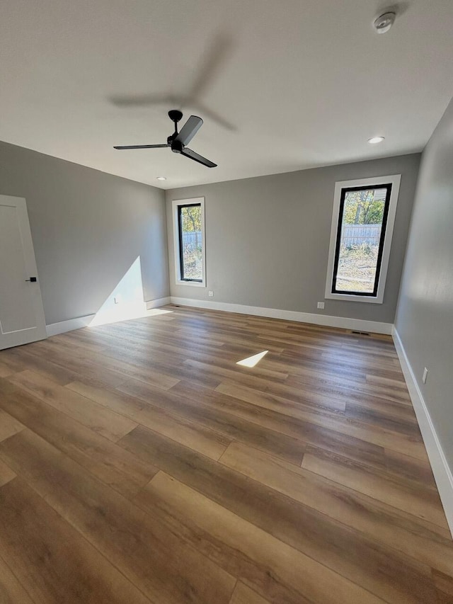 unfurnished room featuring hardwood / wood-style floors and ceiling fan