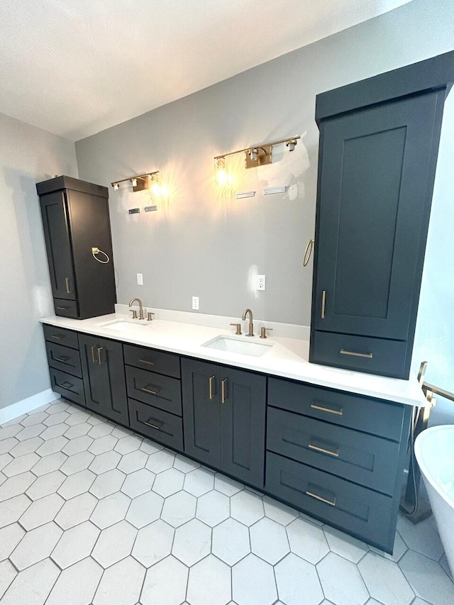 bathroom featuring a bathing tub, tile patterned flooring, and vanity