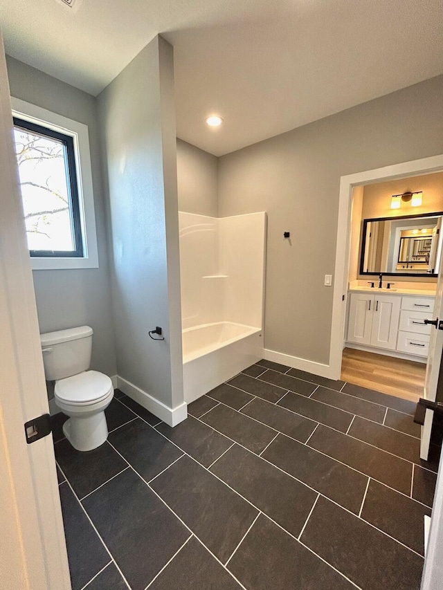 bathroom with tile patterned floors, vanity, and toilet