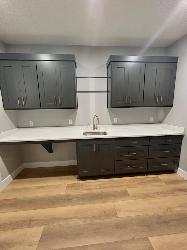 kitchen with sink and light hardwood / wood-style flooring