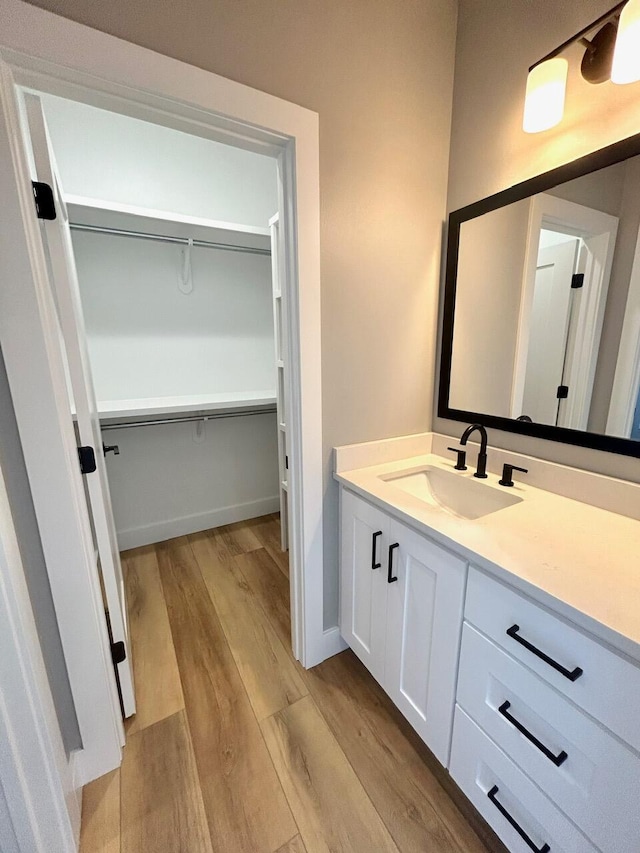 bathroom with hardwood / wood-style floors and vanity