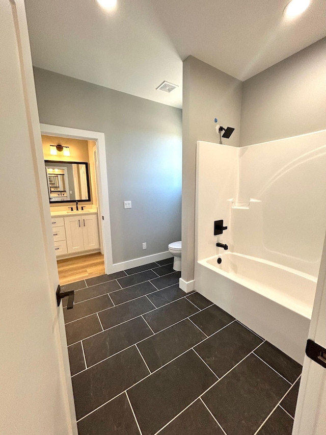 full bathroom featuring tile patterned flooring, shower / tub combination, vanity, and toilet