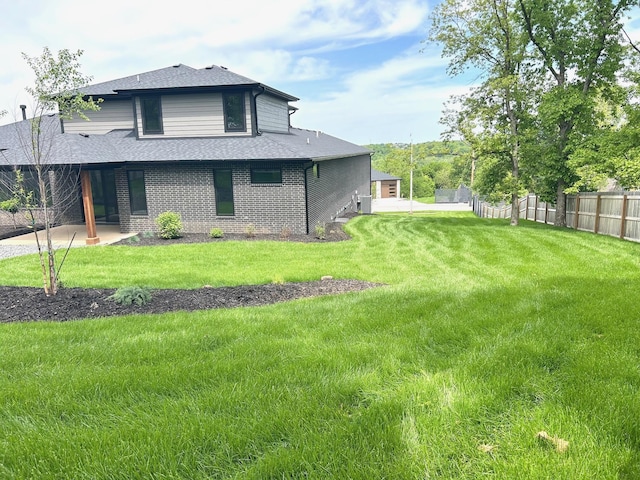 2978 E Kemmling Ln, Springfield, MO 65804 - view of home's exterior with a shingled roof, brick siding, and a patio area