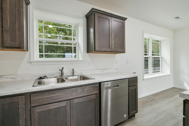 kitchen with dishwasher, light wood-type flooring, sink, and a wealth of natural light