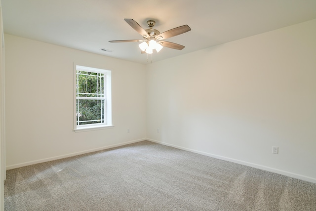 empty room with ceiling fan and carpet floors