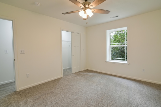 unfurnished bedroom featuring a closet, carpet flooring, and ceiling fan