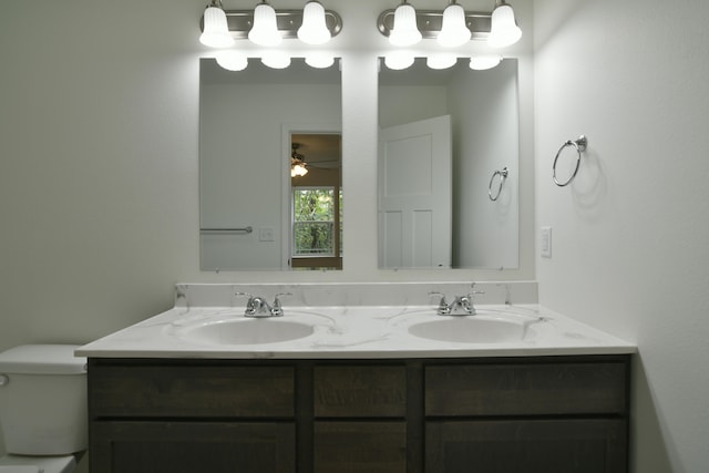 bathroom with ceiling fan, vanity, and toilet