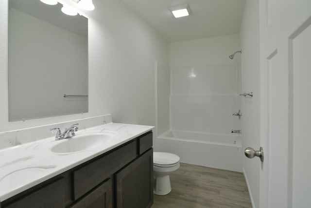 full bathroom featuring shower / tub combination, vanity, toilet, and hardwood / wood-style flooring