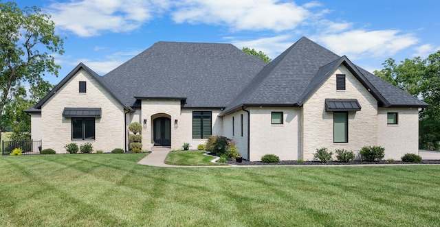 french provincial home with a front lawn