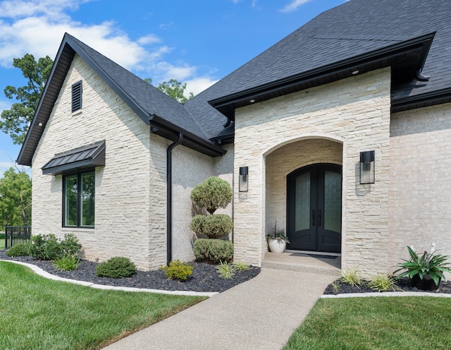 doorway to property featuring french doors and a yard