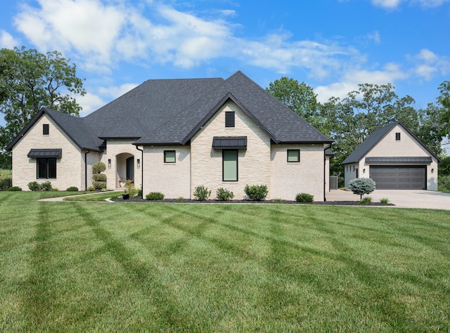 french country home with a garage and a front yard