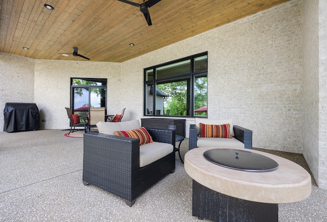 view of patio with an outdoor living space, area for grilling, and ceiling fan