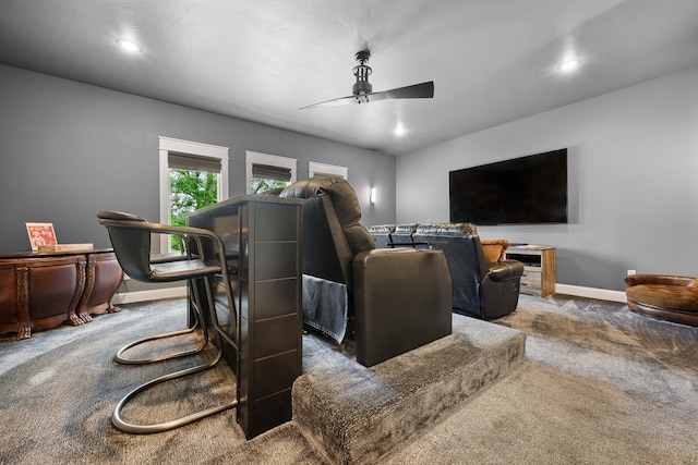 home theater room with carpet floors and ceiling fan