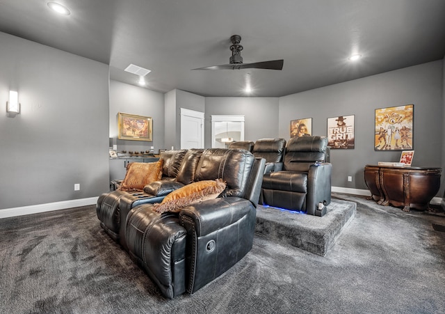 carpeted home theater room with ceiling fan