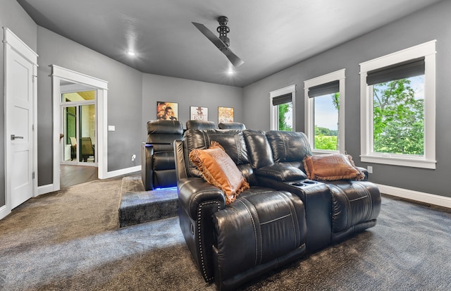 cinema featuring dark carpet and ceiling fan