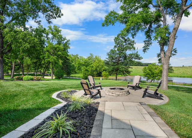 view of patio / terrace featuring a fire pit and a water view