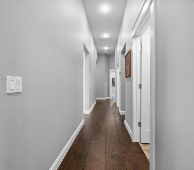 hall with dark wood-type flooring